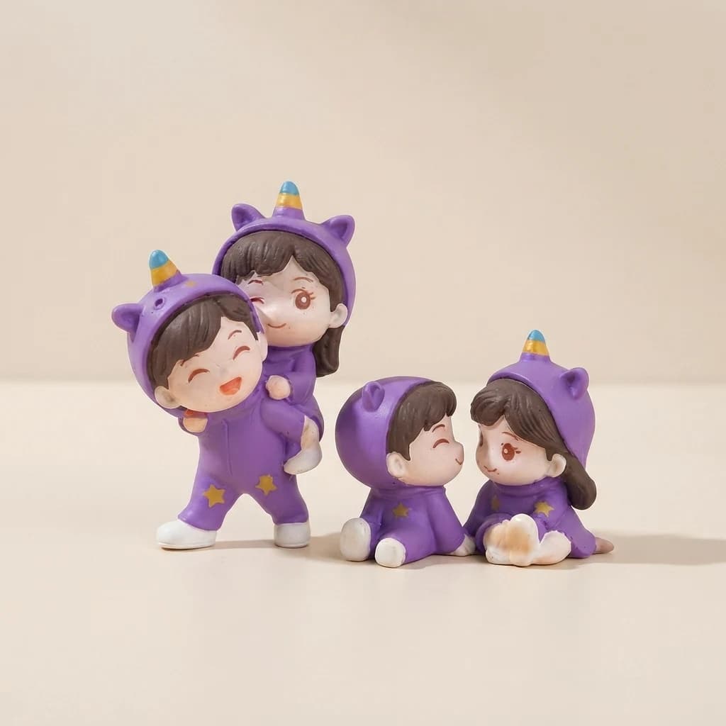 Three-quarter view of cute couple figurines in purple onesies with yellow stars.