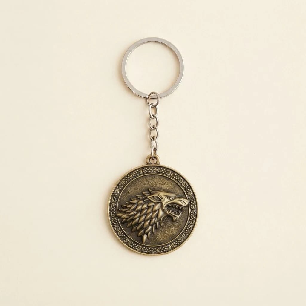 Circular wolf emblem keychain lying flat on a plain cream background.