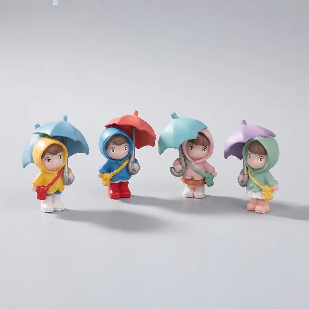 Three-quarter view of four umbrella girl figurines arranged on a light grey background.